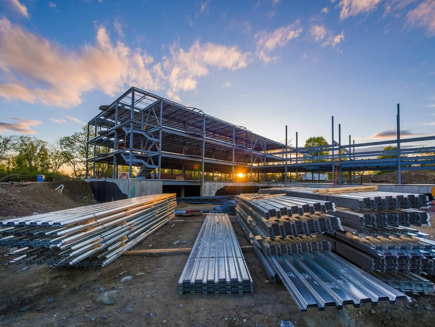 A building under construction with steel beams and metal rails.